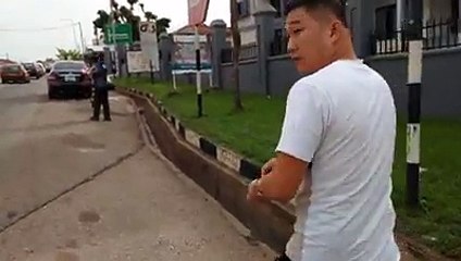 A Man Orders Chinese Man To Pick Up The Trash He Dropped On The Road