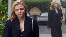 Chloe Grace Moretz flashes her cleavage in a black coat as she waits for her car after lunch date