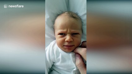 Baby with ridiculously expressive face doesn't like it when dad wakes him up