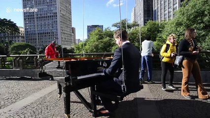 Flying pianist and dancer perform mid-air in Sao Paulo