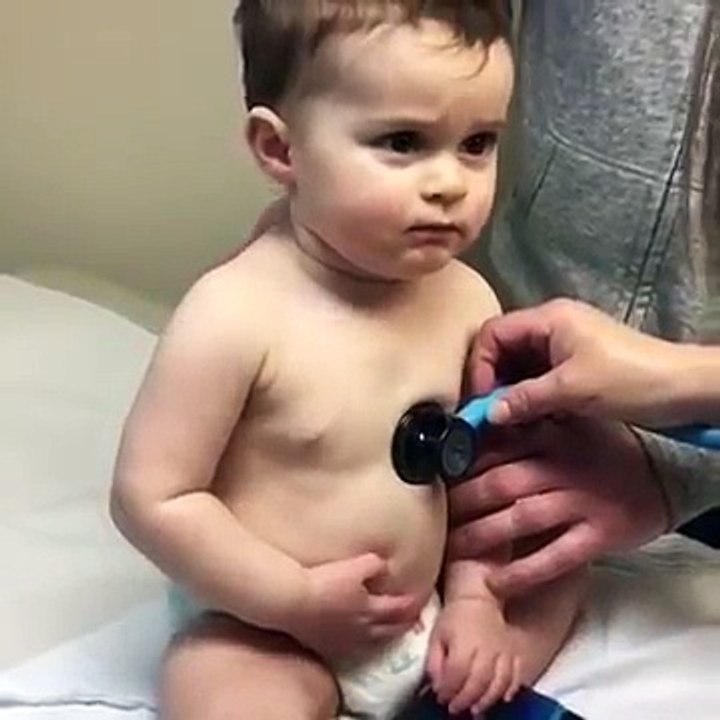Sweet baby boy rests head on nurse's hand