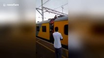 Passenger hanging out of train SLAPS commuter waiting on platform