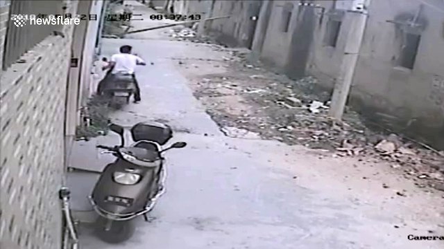 Scooter driver narrowly escapes being buried under collapsed wall