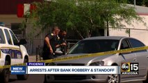 Two bank robbery suspects in custody after hours-long standoff in Phoenix