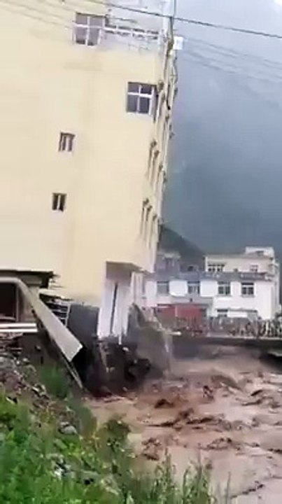 Building going down in salalah oman when heavy flood hits all city.