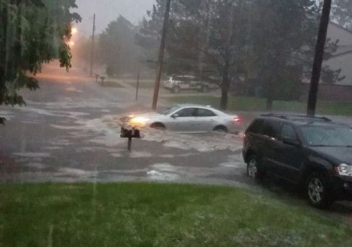 Car Drives Through Flooded Michigan Street