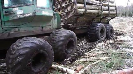 Timberjack 810B logging in winter forest, accident with track