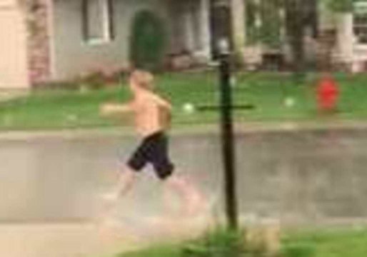Boy Cannot Contain His Excitement as He Plays in Thunderstorm in Meridian, Idaho