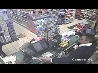 Dramatic moment woman with a knife robs garage