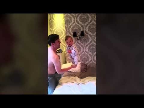 6 month-old baby Lennox balances standing up perfectly on fathers hand