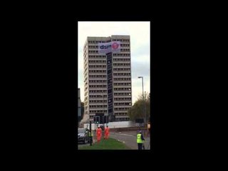 Bungling demolition workers run from the dust following an explosion.