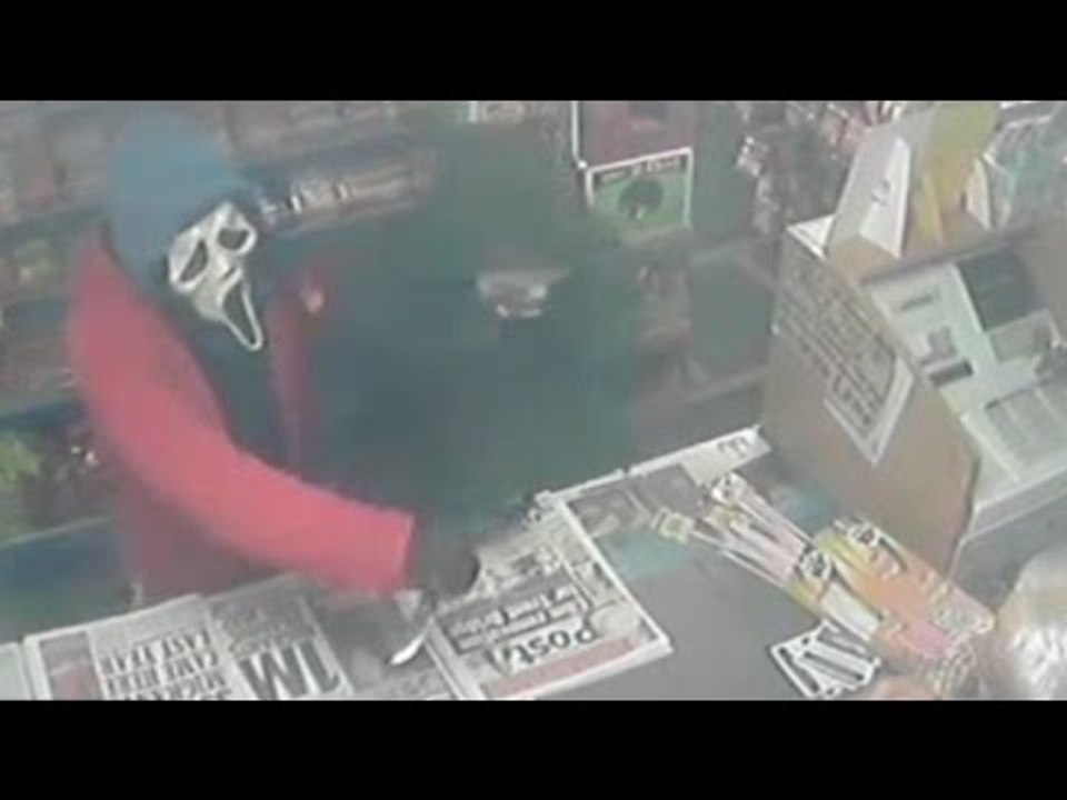 Shopkeepers wife fights off raiders armed with knives and Scream mask