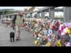 Hundreds of flowers adorn bridge in tribute to air crash victims