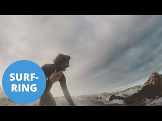 Surfer pops the question to his girlfriend while riding the severn bore
