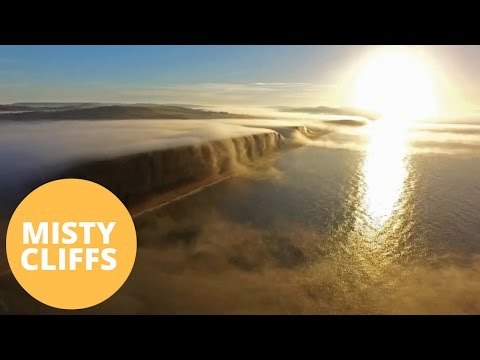 Drone Captures Beautiful Time Lapse Of Mist Flowing Over Cliffs Like A Waterfall