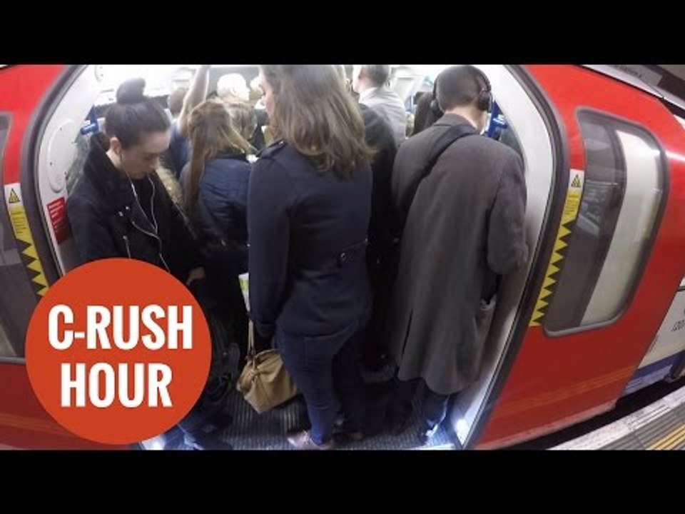Commuters packed together on the London underground.