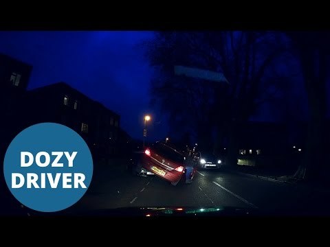 Dozy woman driver mounted two parked cars caught on dashcam.