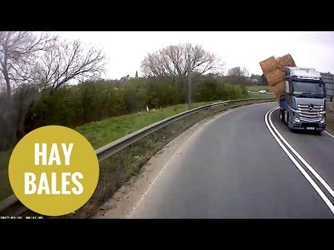 Lorry carrying bales of hay overturned as it took a corner too fast
