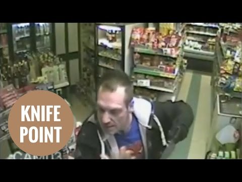 Robber caught on CCTV threatening shopkeeper with knife