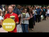 Hundreds of mourners queue to lay flowers in St Ann's Square, Manchester