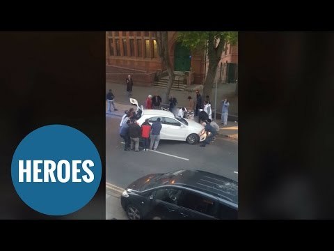 Amazing moment bystanders LIFT a car off a school boy