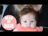 Gorgeous bouncing 12-week-old baby girl born with a thick mop of hair