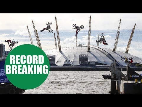 Travis Pastrana performs the first motorcycle backflip between two barges