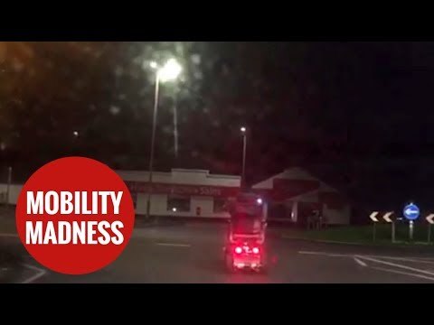 Mobility scooter driver seen riding without lights on roundabout