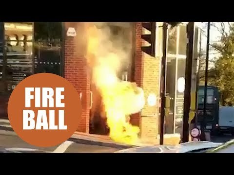 This dramatic footage shows flames bursting out of a manhole cover on a busy city street.