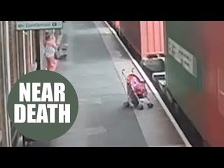 Chilling footage shows moment unattended child's buggy rolls into the path of a freight train