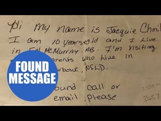 Young boy finds message in a bottle on a Cornish beach