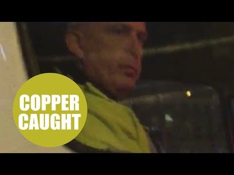 A police officer was caught on camera using his mobile phone