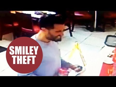Brazen thief caught on CCTV stealing charity box from fast food restaurant while joking with staff