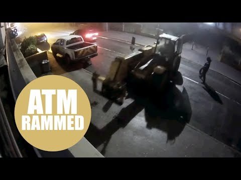 Ram raiders trying to rip cash machine from shop using digger