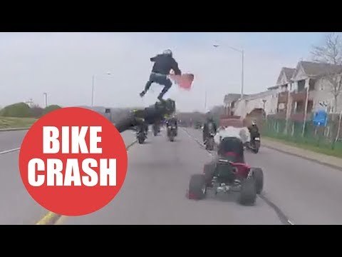 Moment motorcyclist is thrown 10ft into the air after failed wheelie