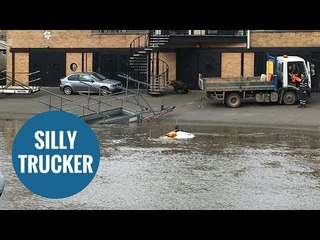 Truck almost completely submerged in river