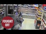 Brave female shop worker fights off armed robber