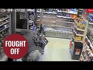 Brave female shop worker fights off armed robber