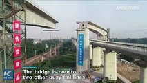 28,000 tons! High-speed railway bridge swivels into position in Henan, China within an hour. The 40 m-high bridge is constructed above two other busy railway li