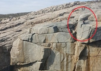 'Idiot' Tourist Spotted Sitting on Steep Cliff Ledge
