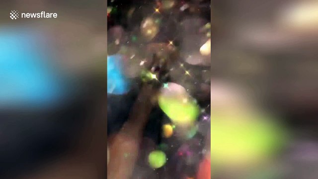 Incredible visual effect after girl sprays glitter at camera