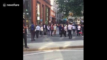 Crowds gather at cordoned-off area near luxury hotel