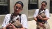 Kylie Jenner holds baby Stormi in a $625 GUCCI baby carrier as she attends North and Penelope's birthday bash
