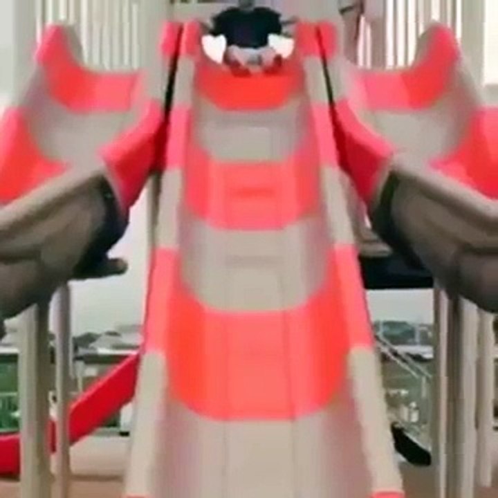 kid sliding down slide hits head