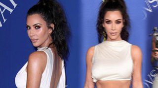 Kim Kardashian goes braless in an abs-flashing cream crop top and skirt as she shares her shock at CFDA Fashion Award because she's 'always NAKED'