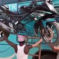 Indian Guy Balancing Motorbike On Head