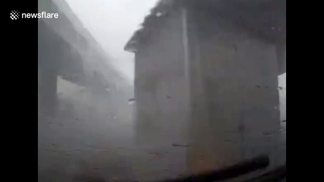 Portacabin blown across road in strong China winds
