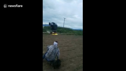 Watch an all-terrain vehicle ride vertically on its front wheels