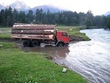 Russian Truck Filled With Hulking Logs Crosses River