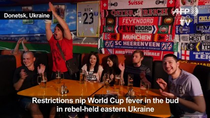 Citizens of war-torn Donetsk watch World Cup opening